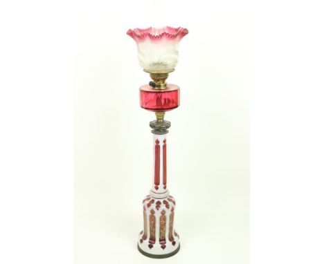 A fine 19th Century Bohemian overlaid white and ruby glass Table Oil Lamp, with brass mounts and ruby glass reservoir and mou