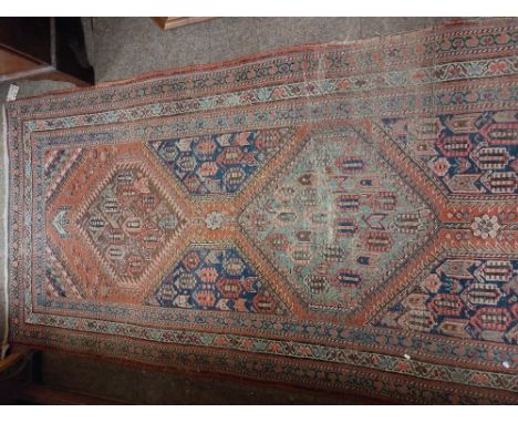 An attractive antique Middle Eastern&nbsp;woollen&nbsp;Carpet Runner,&nbsp; the central panel on claret ground with five meda