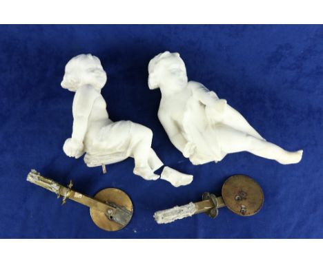 A pair of 19th Century carved white marble Figures, of seated cherubs 28cms (11"), each on a circular brass bracket. (2) 