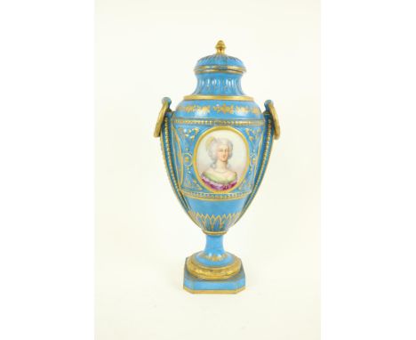 An attractive Sevres style porcelain Urn and Cover, in celeste blue floral and gilt decoration, ring handles in the form of w