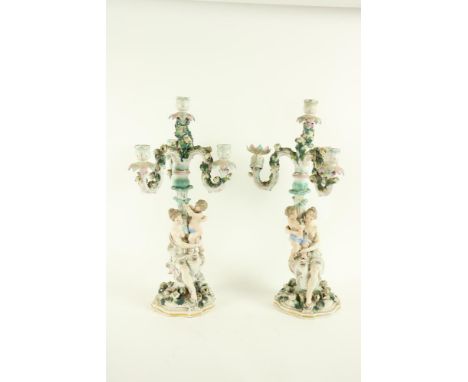 A pair of Dresden porcelain&nbsp;Candelabra, each with three flower encrusted arms and a centre light, the stem in the form o