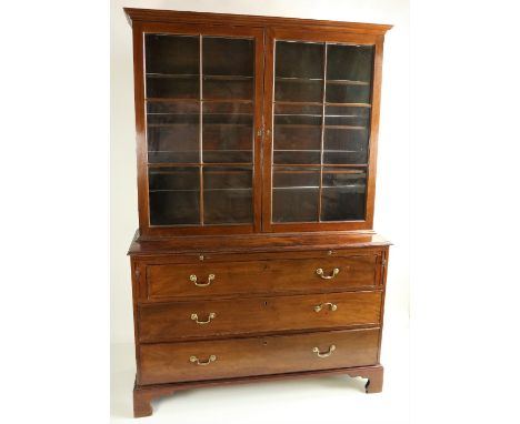 An unusual George III period mahogany Bookcase, with moulded cornice above two six panel glazed doors, on a chest base with w
