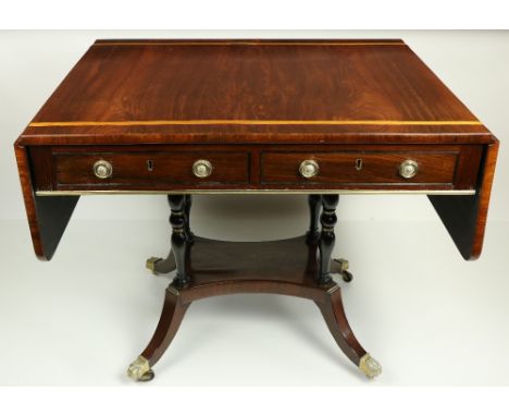 A Regency period satinwood banded rosewood Sofa Table, the rectangular flaps with rounded corners, flanking two mock and two 