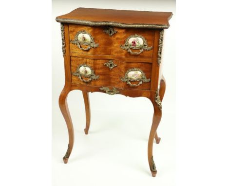 A serpentine shaped French walnut and brass mounted Petite Commode, with brass mounts and porcelain panels and two drawers, t