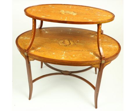 An oval Edwardian two tier marquetry inlaid satinwood Supper Table, the top inlaid with musical trophies, chained husks and f
