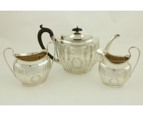 An oval bright cut tapering reeded silver Teapot, Chester 1924, with ebonised handle; together with a matched Birmingham silv