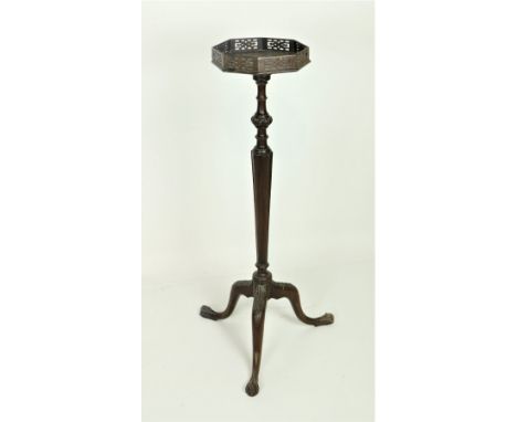 An attractive Georgian style mahogany Plant Stand, the octagonal top with pierced decorated railing over a shaped tapering pi