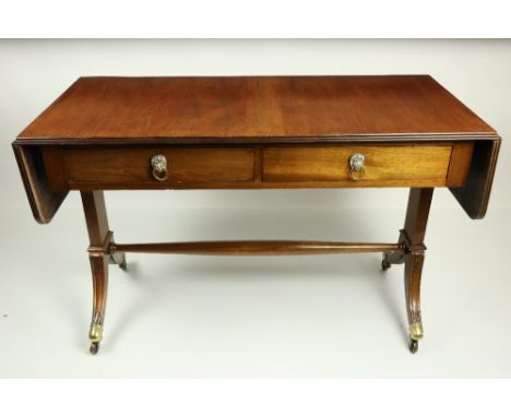 A Regency style mahogany drop leaf Sofa Table, with two rectangular flaps flanking two frieze drawers on standard supports an