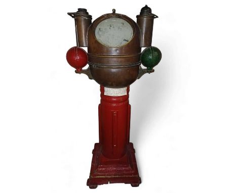 A late 19th century binnacle. By Lilley & Reynolds London.  The domed brass hood flanked by iron spheres over a compass on a 