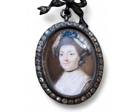 Miniature A fine Georgian portrait miniature of a lady, a blue ribbon in her lace bonnet 3x2.5cm in paste set pendant mount.T