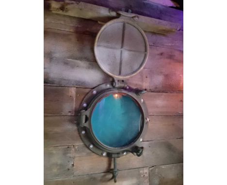 A Porthole Used within The Shackleton Exhibition  Glass 30cm in diameter, 55cm in total.