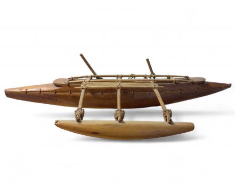 An early 20th Century Model of a South Polynesian Outrigger Canoe Wooden canoe with ropework thread fastenings and miniature 