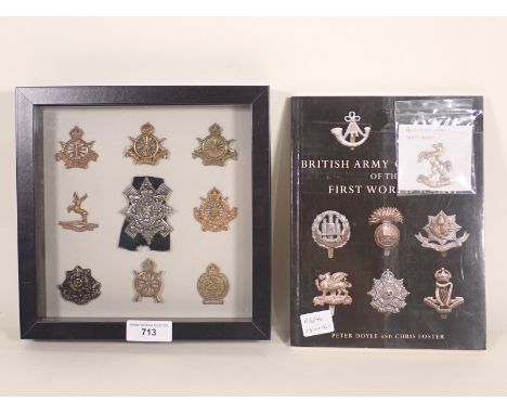 A framed collection of nine British Army Regiment Cap Badges including Army Cyclist Corps, Huntingdonshire and East Yorkshire