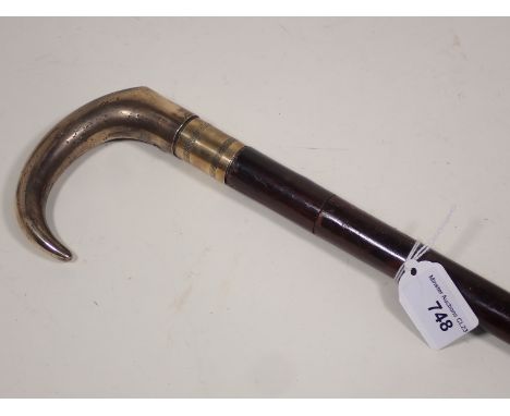 A de-activated Walking Stick Gun with brass handle and no operating parts 