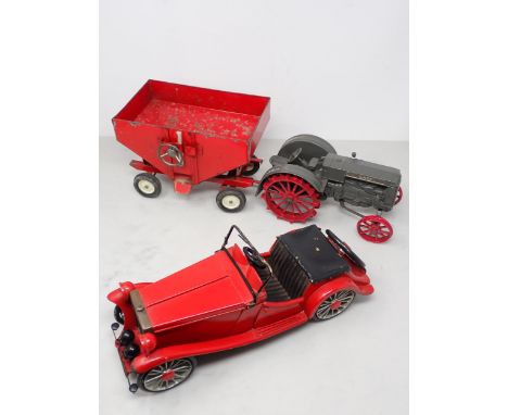 A metal Model of a Case Tractor and Hopper Trailer and a tinplate Model of a red open seater Car 