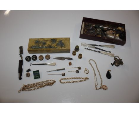 A hardstone and mother of pearl inlaid trinket, contents of various studs; buttons; thimbles; bottle stoppers; mother of pear