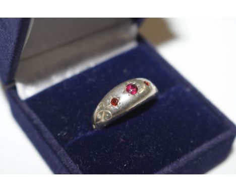 A white metal and garnet set gipsy ring 