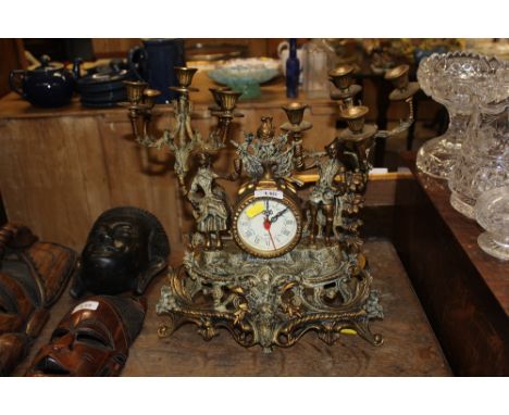 A mantle clock and garnitures 