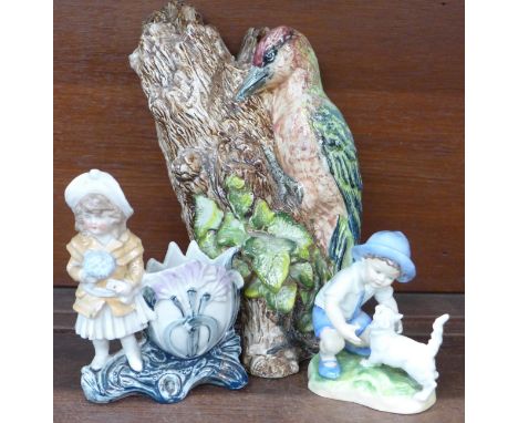 A Royal Worcester figure, September modelled by F.G. Doughty, a continental spill holder and a large model of a woodpecker, a