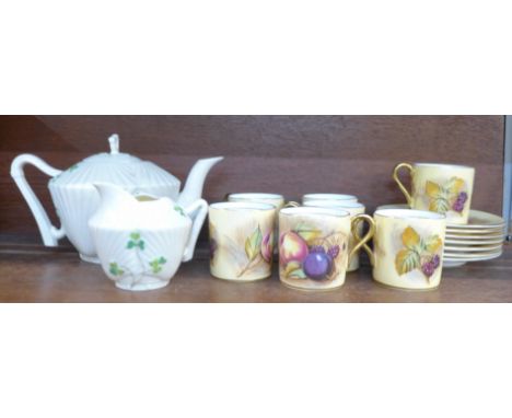 Seven Aynsley coffee cans and saucers decorated with fruit and a Belleek teapot and cream jug, (black backstamp)