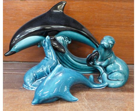 Three items of Poole pottery and one other, including a Dolphin, Seal a/f