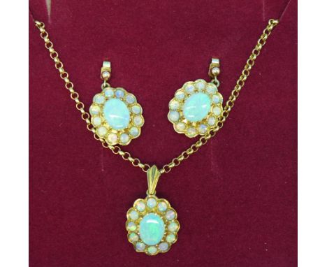 A 9ct gold and opal pendant on a 9ct gold chain with a matching pair of earrings, 9g