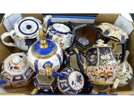 A collect of seven Imari teapots, teapot stands and jugs