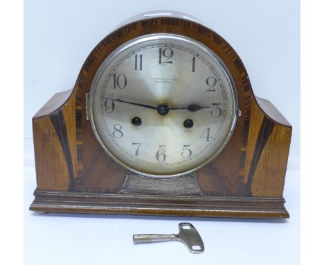 An Art Deco cased mantel clock with striking movement, Pleasance and Harper, Shrewsbury, with presentation plaque dated 1954