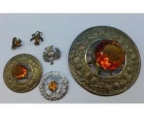 A large Scottish kilt sash brooch set with a Cairngorm, along with two smaller kilt sash brooches, a pair of silver Cairngorm