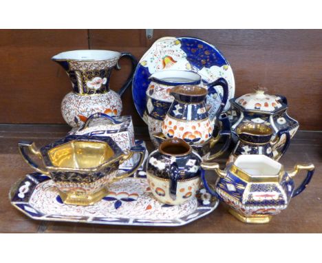 A collection of Imari jugs, a platter, butter dish, plates, etc., one jug a/f