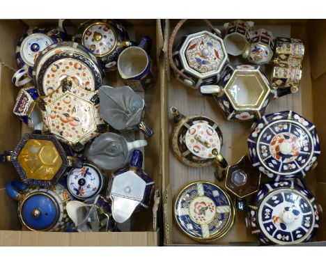 A collect of Imari teapots, teapot stands, jugs, sugar bowls, etc.