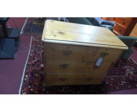An Edwardian pine chest of two short over three long drawers with original brass handles and raised on bracket supports, H.76