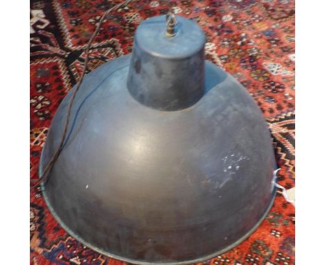 A large industrial copper ceiling light shade 