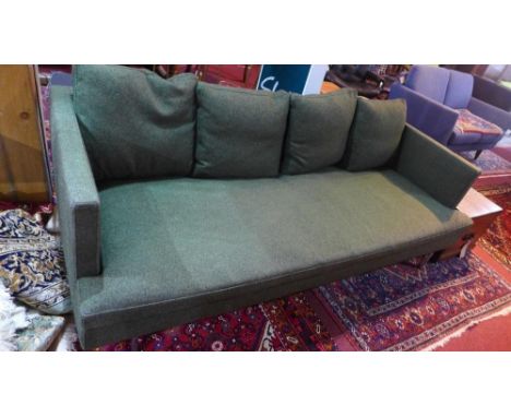 A contemporary Ligne Roset three seater sofa with dark green upholstery on chrome supports 