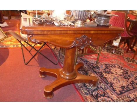 A Victorian mahogany card table, raised on pillar support and quad base 