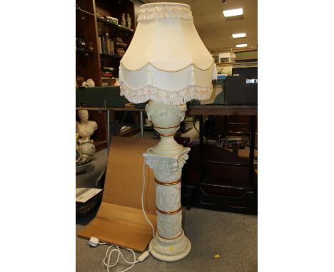 A DECORATIVE CREAM LAMP ON FIGURATIVE COLUMN STAND 