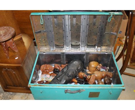 A PAINTED STEEL TRUNK CONTAINING AFRICAN STYLE TREEN FIGURES AND MASKS