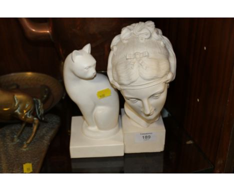 A SMALL PORCELAIN BUST OF A LADY TOGETHER WITH A CERAMIC CAT FIGURE 