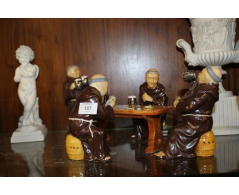 A CERAMIC FIGURE GROUP OF MONKS IN A TAVERN 