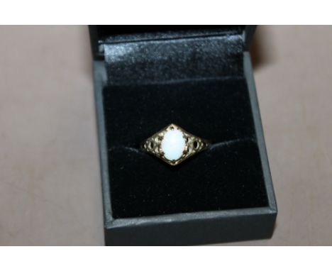 A LADIES 9CT GOLD DRESS RING SET WITH AN OPAL