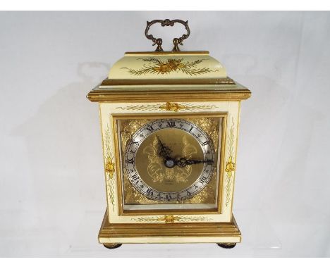 A mantel clock in the style of an early English bracket clock by Elliotts of London, Honduras mahogany case enhanced with flo