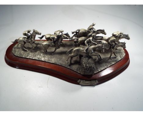 A Craftman's Studio Model figurine depicting horse racing on a wooden plinth entitled National Hunt, issued in a limited edit