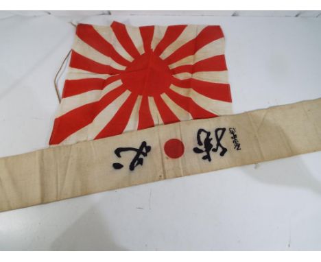 World War Two (WW2) - a Japanese flag, approx. 35 cm x 40 cm and a Japanese sash bearing a red circle flanked by printed blac