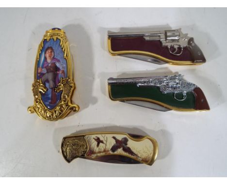Four Franklin Mint collectors knives comprising a Lord of the Rings knife, two depicting guns and one decorated with pheasant
