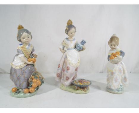 Lladro - Three Lladro figurines comprising 4841 'Valencian Girl', 1422 'Miss Valencia' and 5254 'Making Paella', the largest 