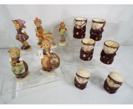 Five Goebel Hummel figurines and a set of egg cups and cruets by Weiss