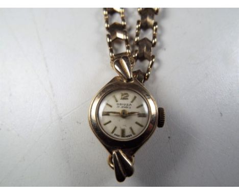 A lady's 9 carat gold wristwatch, stamped to strap 9ct (925), manual wind signed to the dial Oriosa 17 jewels, total weight 1