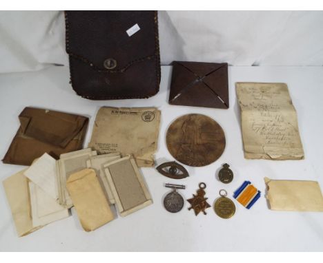 A World War One (WW1) medal group comprising the Death Plaque in original board packet with Army form B104-82 (notification o