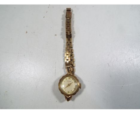 A lady's 9 carat gold wristwatch on a 9 carat gold strap, manual wind movement signed to the dial Renown, total weight 16.3 g