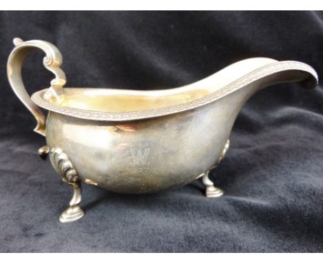 A hallmarked silver sauce boat on three pad footed legs. assay Sheffield 1925. Maker M&W